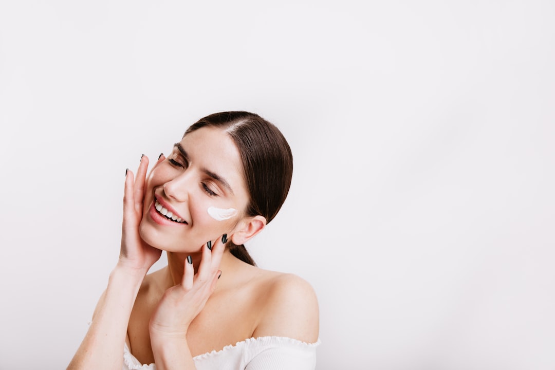 Woman with a defined jawline touching her face, showing the V-shape facial contour that RF lifting treatments target