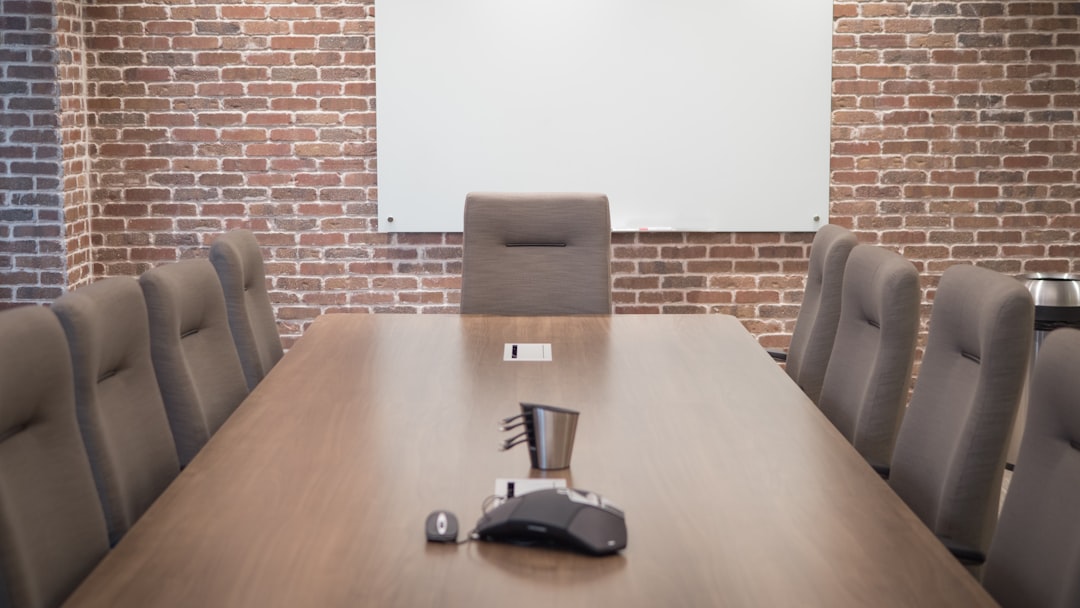 Conference room with projector screen and chairs set up for a corporate meeting