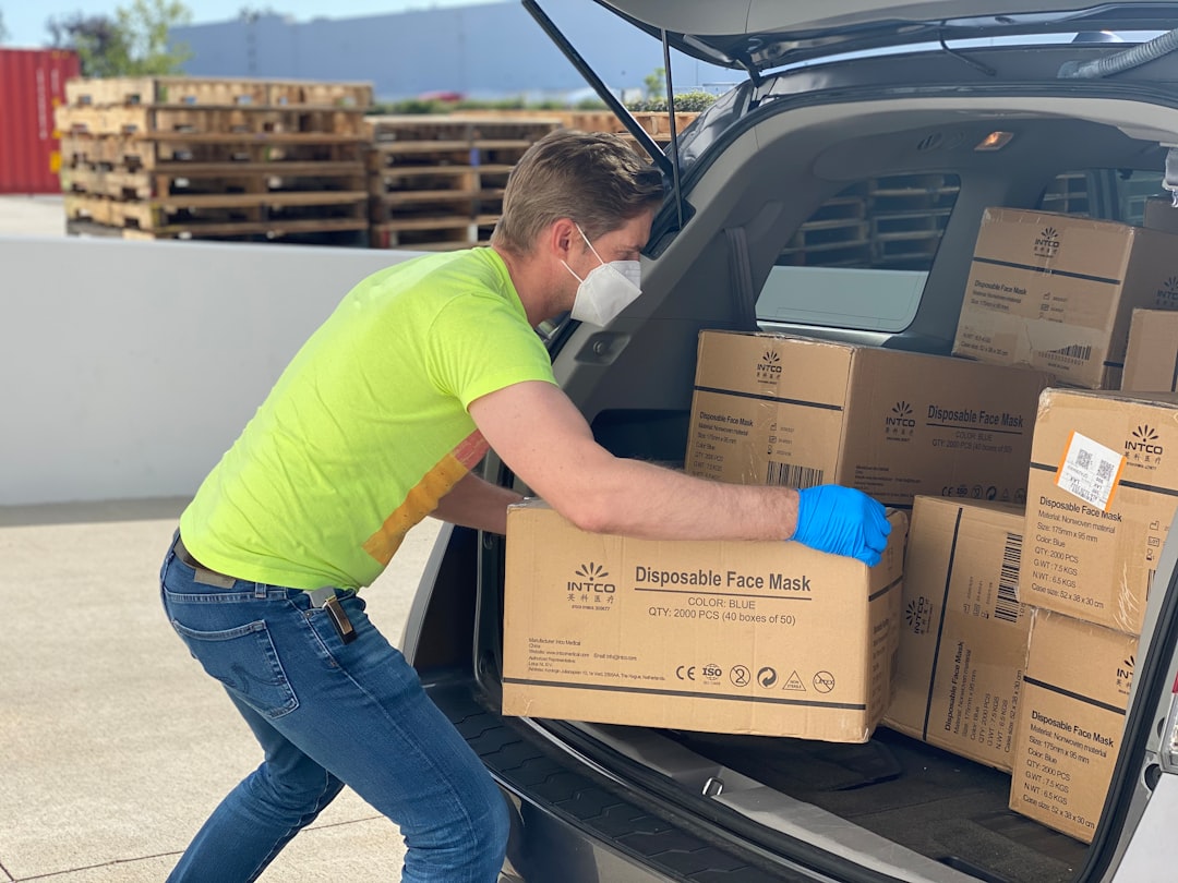 Delivery person carrying equipment boxes for event setup
