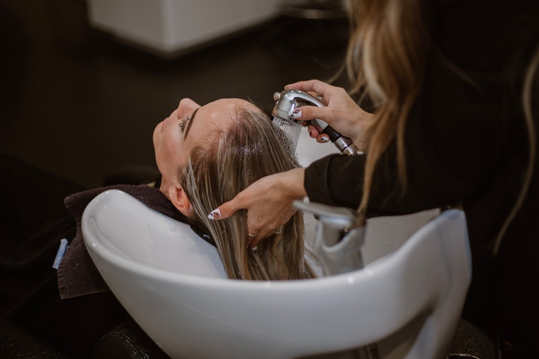 Woman receiving professional scalp treatment at spa