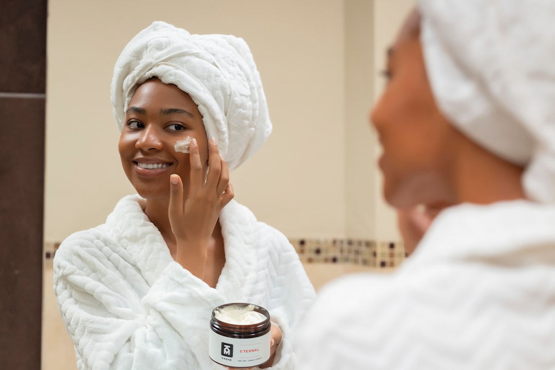 Person applying gentle moisturizer as part of a sensitive skin care routine