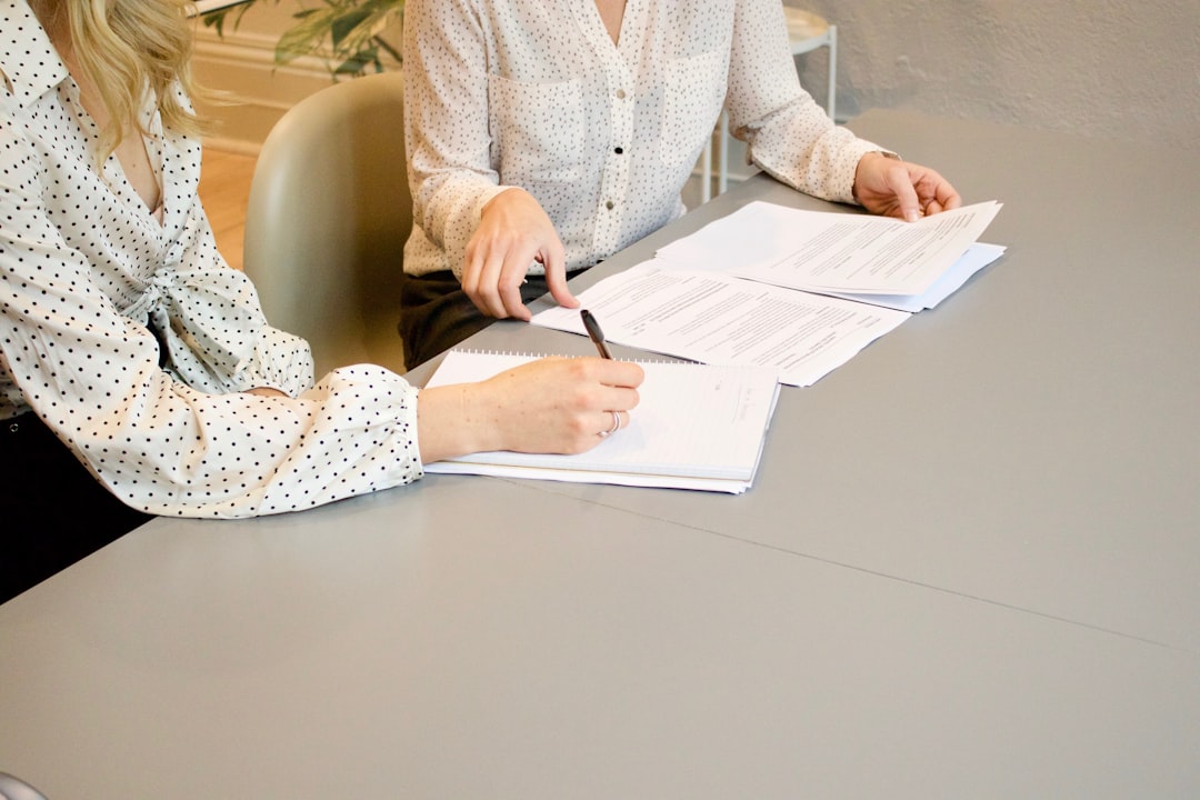 Event planner and vendor reviewing and signing a contract with insurance documents