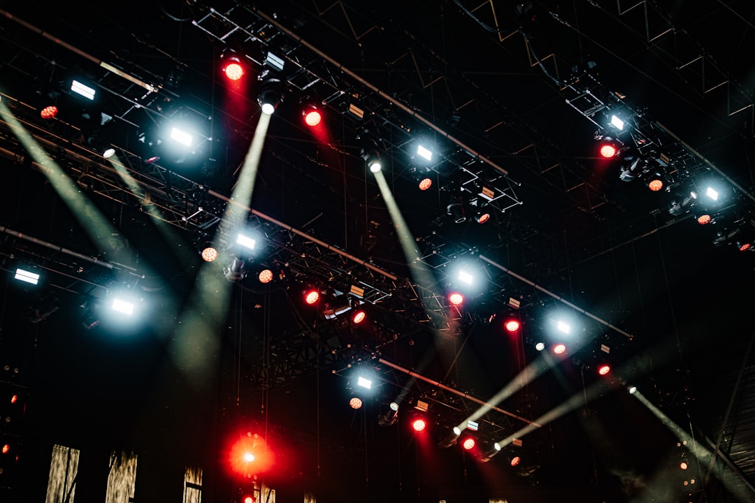 AV crew rigging truss and lighting equipment for a corporate event stage