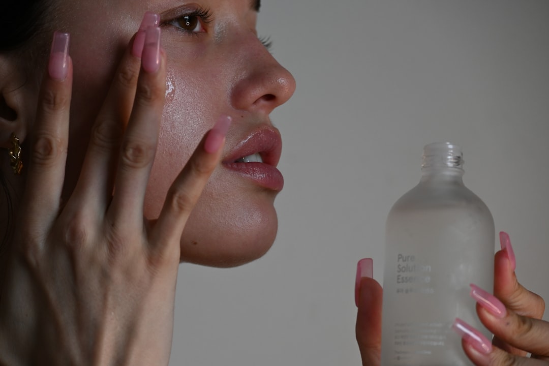 Woman applying calming skincare cream to her face