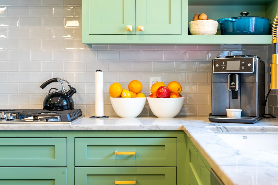 Kitchen with green cabinets and hardware pulls