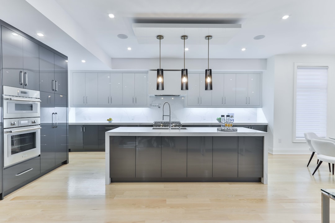 Modern grey handleless kitchen cabinets with white island
