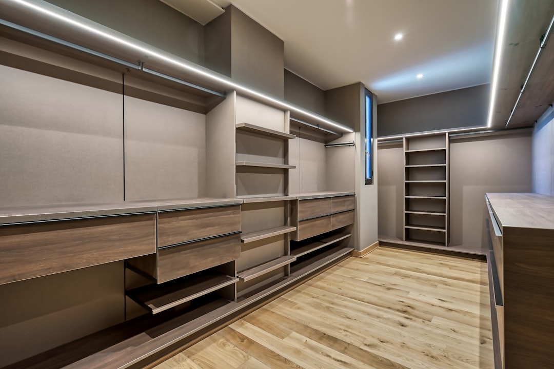 Spacious walk-in closet with wooden built-in shelving