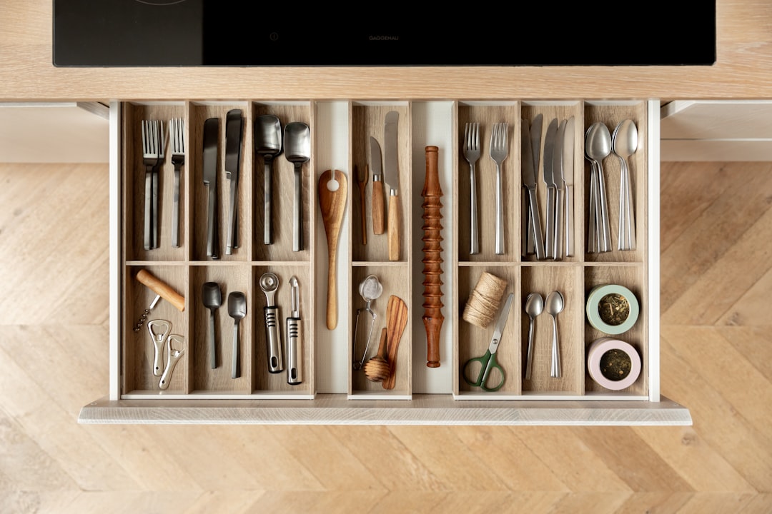 Organized kitchen drawer with utensils in a handleless cabinet system