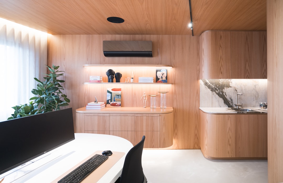 Modern home office with wood paneling and built-in storage