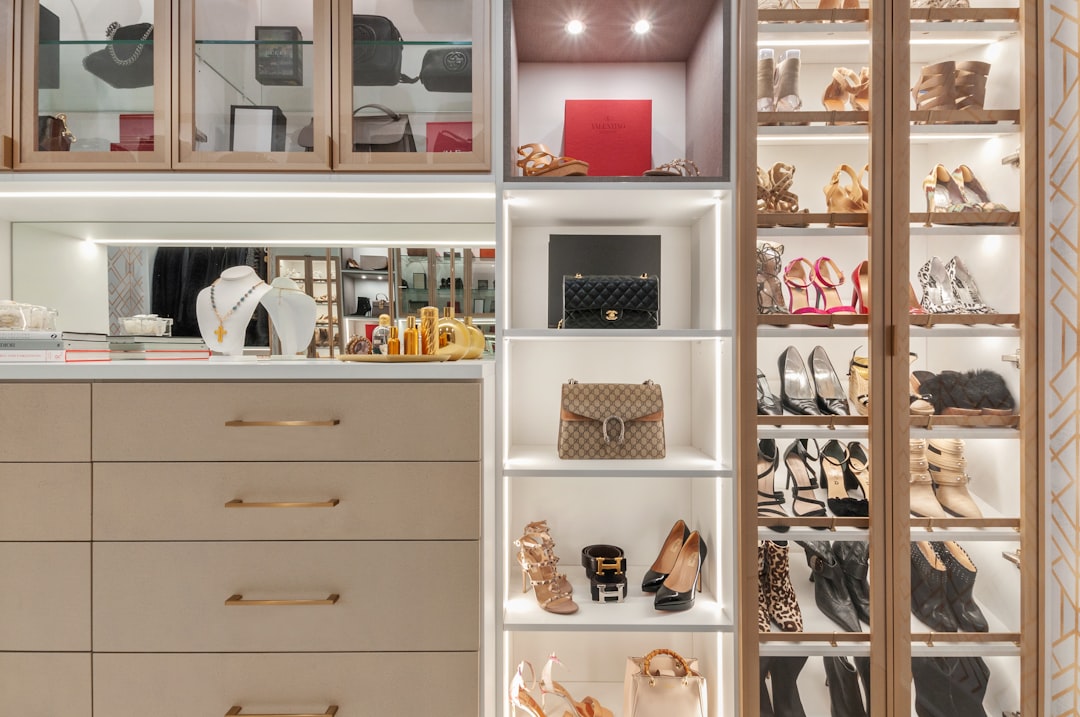 Organized reach-in closet with shelving and folded items