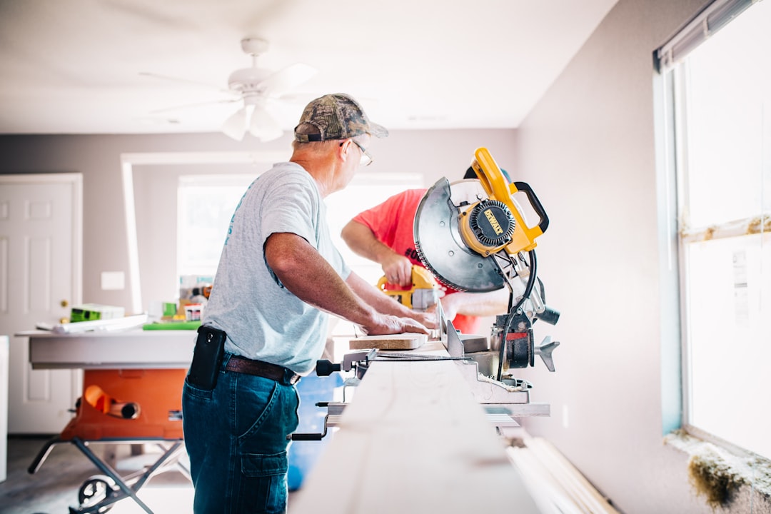 Carpenter working with a miter saw during kitchen cabinet installation