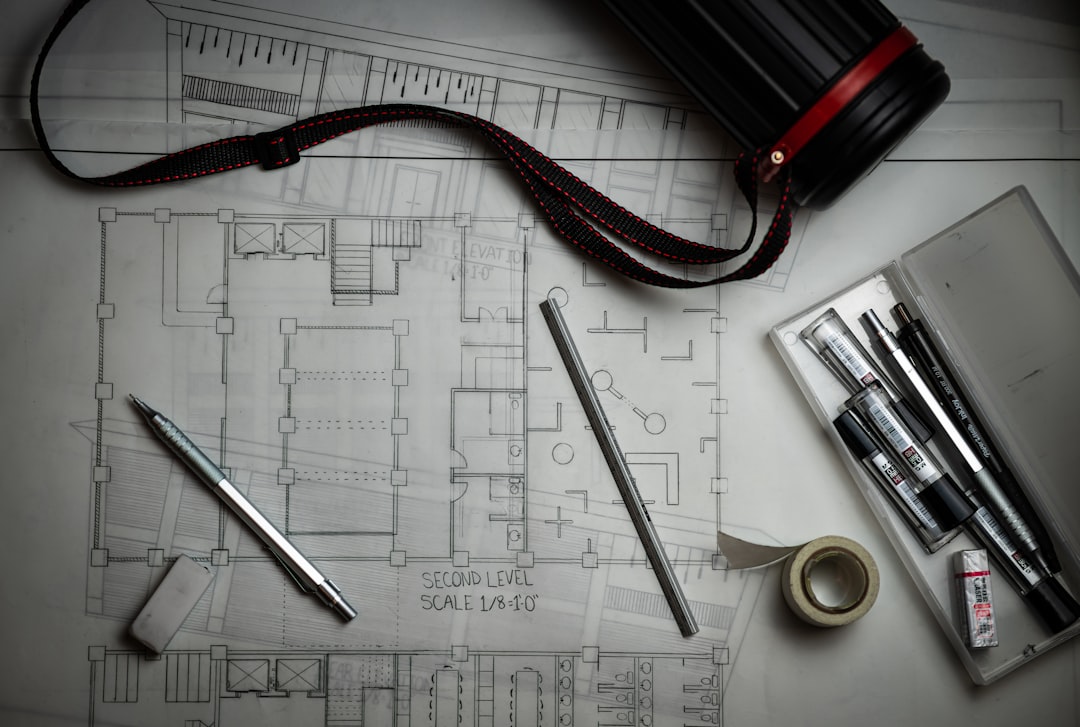 Kitchen design blueprints and drafting tools on a table during planning consultation