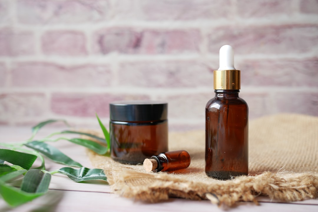 Amber glass bottle of essential oil on a textile background