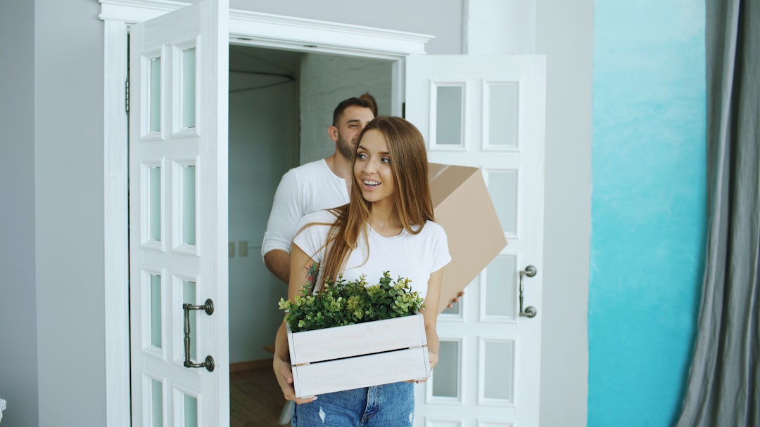 Couple receiving a delivery inside their new home