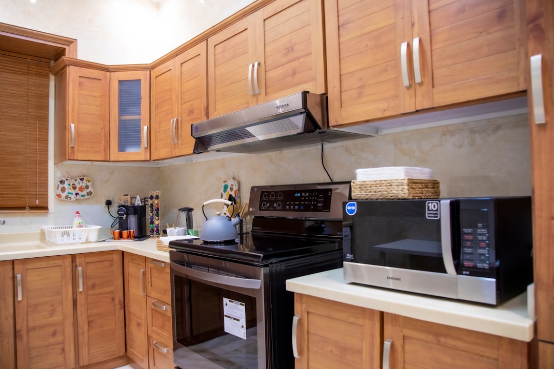 Warm-toned wooden kitchen cabinets with modern appliances
