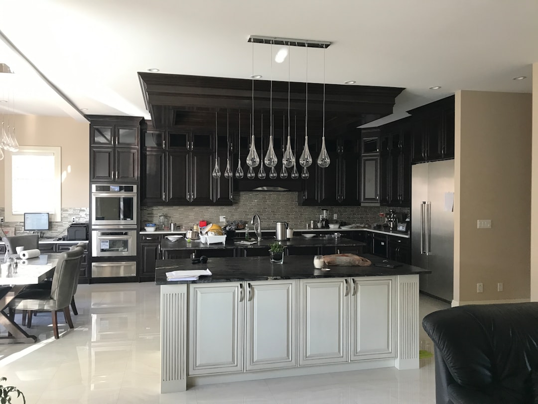 Renovated kitchen with dark upper cabinets and light island cabinetry