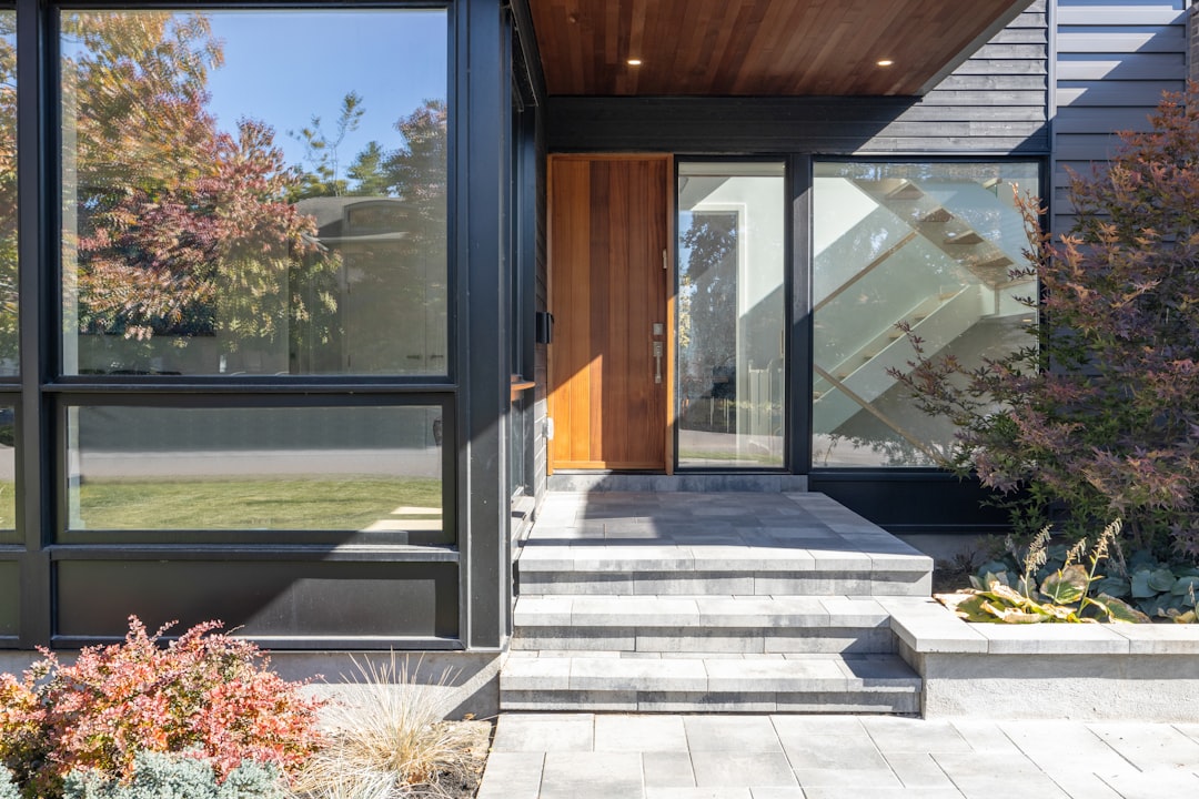 Modern glass and pivot front door entrance with clean minimalist lines