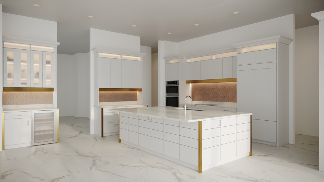 White kitchen with marble countertop and light backsplash tile